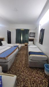 Ένα ή περισσότερα κρεβάτια σε δωμάτιο στο عمارة روتانا