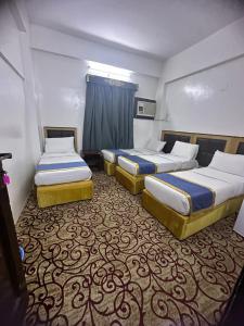 Ένα ή περισσότερα κρεβάτια σε δωμάτιο στο عمارة روتانا