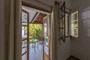 an open door to a patio with a table at Resort Fazenda 3 Pinheiros in Engenheiro Passos
