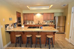 a kitchen with a island with bar stools at King- Lake Area in Bass Lake
