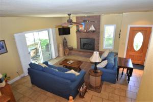 a living room with blue couches and a fireplace at King- Lake Area in Bass Lake