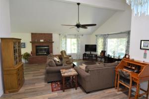a living room with a couch and a piano at Brummett Lodge in Bass Lake