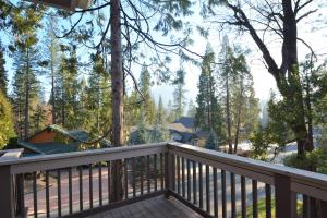a deck with a view of the woods at Feinstein- Lake Areafree Night Special in Bass Lake