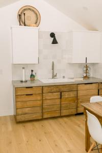 a kitchen with wooden cabinets and a sink at Casita- Lake Area in Bass Lake +37 photos