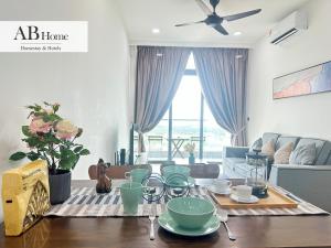 a living room with a table with dishes on it at ABHOME "JAPAN SUITE" #GreenHaven #Olympic Pool #360"SeaView #JB in Johor Bahru