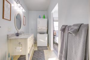 a white bathroom with a sink and a refrigerator at 4 Mi to Lake Logan Hocking Hills Apartment in Logan