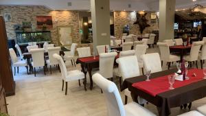 a dining room with tables and white chairs at Laguna Resort SPA in Augustów +37 photos