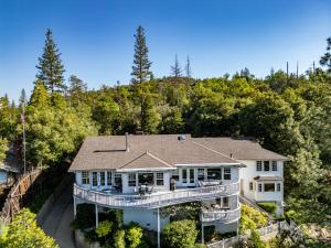 an aerial view of a house with a large deck at Falls Lake View in Bass Lake