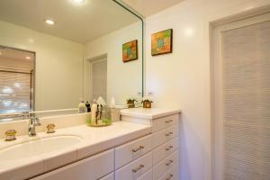 a bathroom with a sink and a large mirror at Falls Lake View in Bass Lake +14 photos