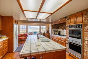 a kitchen with a counter top and a brick wall at Falls Lake View in Bass Lake
