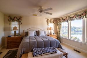 a bedroom with a bed and a large window at Falls Lake View in Bass Lake
