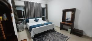 a bedroom with a large bed and a mirror at Mamzar Beach Side Private Room at Sharjah-Dubai Border in Sharjah