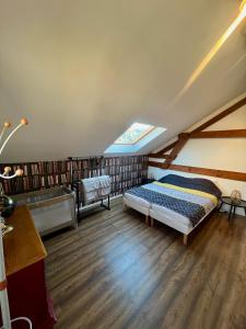 a bedroom with a bed in a attic at Grand apt La Bresse 6 a 8 pers centre et pistes proches in La Bresse