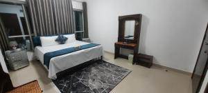 a bedroom with a king sized bed and a mirror at Mamzar Beach Side Private Room at Sharjah-Dubai Border in Sharjah +13 photos