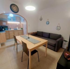 a living room with a table and a couch at Angie's House Volos in Volos