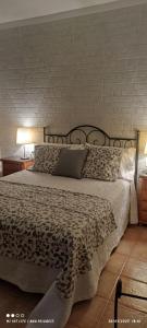 a bedroom with a bed with a black and white bedspread at Casa Arena Negra Edificio A'costa in Puerto Naos
