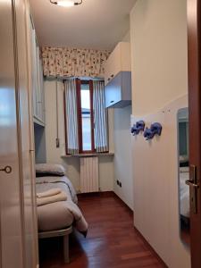 a small room with two beds and a window at Roses house in Porto San Giorgio