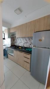 una cucina con frigorifero e armadietti in acciaio inossidabile di APTO ACONCHEGANTE 1km da praia do Aracagy e 4km da av litorânea a São Luís