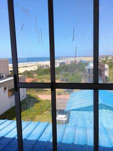 a view of the ocean from a window at 28 de Octubre in Punta Del Diablo
