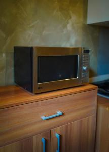 a microwave sitting on top of a wooden cabinet at Binario 14 Piazza Garibaldi in Naples