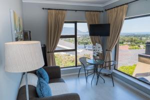 a living room with a couch and a table at Grandview Guesthouse in Cape Town