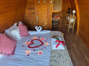 a bed with candles on it in a room at Casa da Avó Miquinhas in Paços de Ferreira