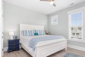 a white bedroom with a bed and a window at Luxury Th In Emerald Isle, Nc Welevator in Emerald Isle +33 photos