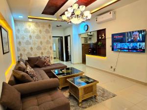 a living room with a couch and a tv at Opulent 5-BHK Entire House in Bahria Town Phase 3 in Rawalpindi