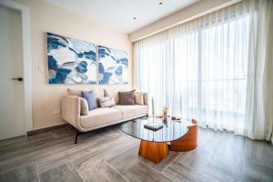 a living room with a couch and a table at Aston Rubi City Suites in Santo Domingo +36 photos