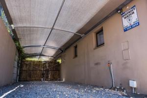 a garage with a gate and a building at Grandview Guesthouse in Cape Town