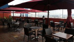 a restaurant with tables and chairs and umbrellas at El Hana International in Tunis