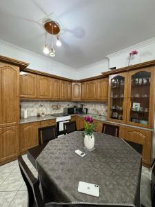 a dining room with a table and a kitchen at jo&ju new in Athens