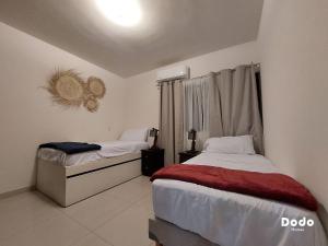 Un pat sau paturi într-o cameră la Departamentos en el centro de Mazatlán