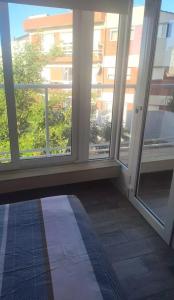 a room with large windows in a building at Ale-MardelPlata-Sicilia in Mar del Plata