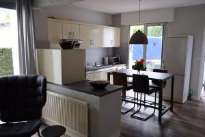 a kitchen with a table and chairs in a room at Villa les Fontaines in Lanton