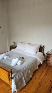 a bedroom with a bed with towels on it at Triantafillia - Mountain Lodge by Ladonia Εpi in Likouría