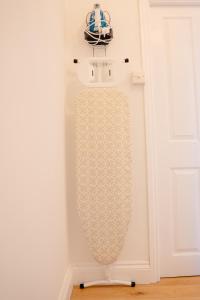 a mirror hanging on a wall next to a door at Modern 2 bed Bromley House in Grove Park