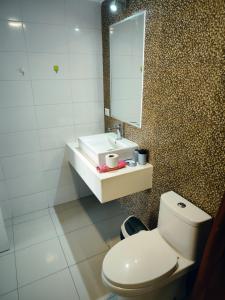 a bathroom with a white toilet and a mirror at Depa Bonito en Condominio ! in Tacna +13 photos