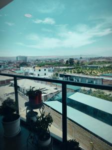 a balcony with plants and a view of a city at Depa Bonito en Condominio ! in Tacna