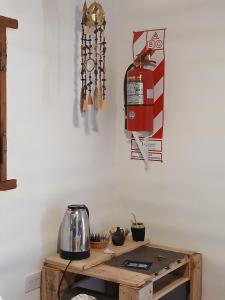 a wooden table with a tea kettle on a wall at Pacha Wasi in Humahuaca