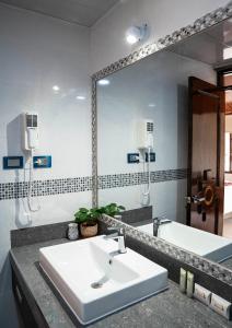 a bathroom with a sink and a large mirror at Hotel Tierra Inka Sacred Valley in Ollantaytambo