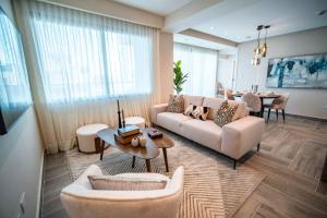 a living room with a couch and chairs and a table at Aston Rubi City Suites in Santo Domingo
