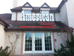 a american house sign on top of a building at American House Puławska in Warsaw