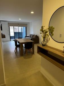 a living room with a table and a mirror at Departamento Premium Aqua II in Villa Carlos Paz