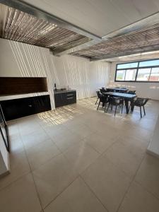 a large room with a table and chairs in it at Departamento Premium Aqua II in Villa Carlos Paz +10 photos