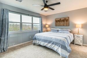 a bedroom with a bed and a large window at Less Than 1 Mi to Boat Ramp Waterfront Lake Conroe Home! in Montgomery