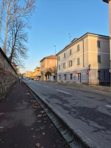 an empty street with buildings on the side of the road at MoMa Home Villasanta Monza Park in Villasanta +8 photos