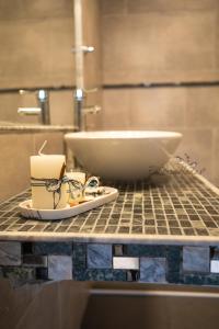 a bathroom counter with a bowl and a candle on it at EmBruHadas Relax in San Salvador de Jujuy