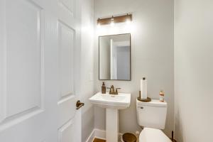 a white bathroom with a sink and a toilet at 7 Mi to Talladega Superspeedway Home with Lake View in Lincoln