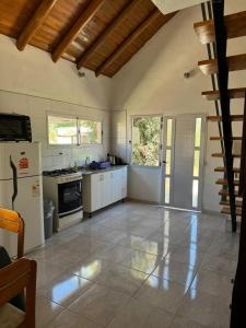 a kitchen with a stove and a refrigerator at San rafael del diamante apartamentos in San Rafael